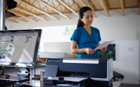 Lady in office using HP Officejet Pro printer
