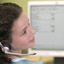 woman with headset giving 24/7 toll free phone support